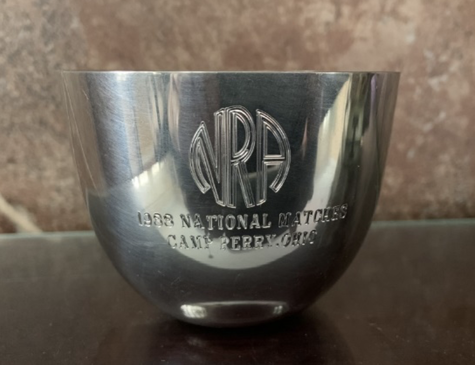 A close-up of the 1988 Jefferson Cup Trophy. The bowl is silver, with the NRA logo engraved on it above the words "1988 National Matches, Camp Perry, Ohio."