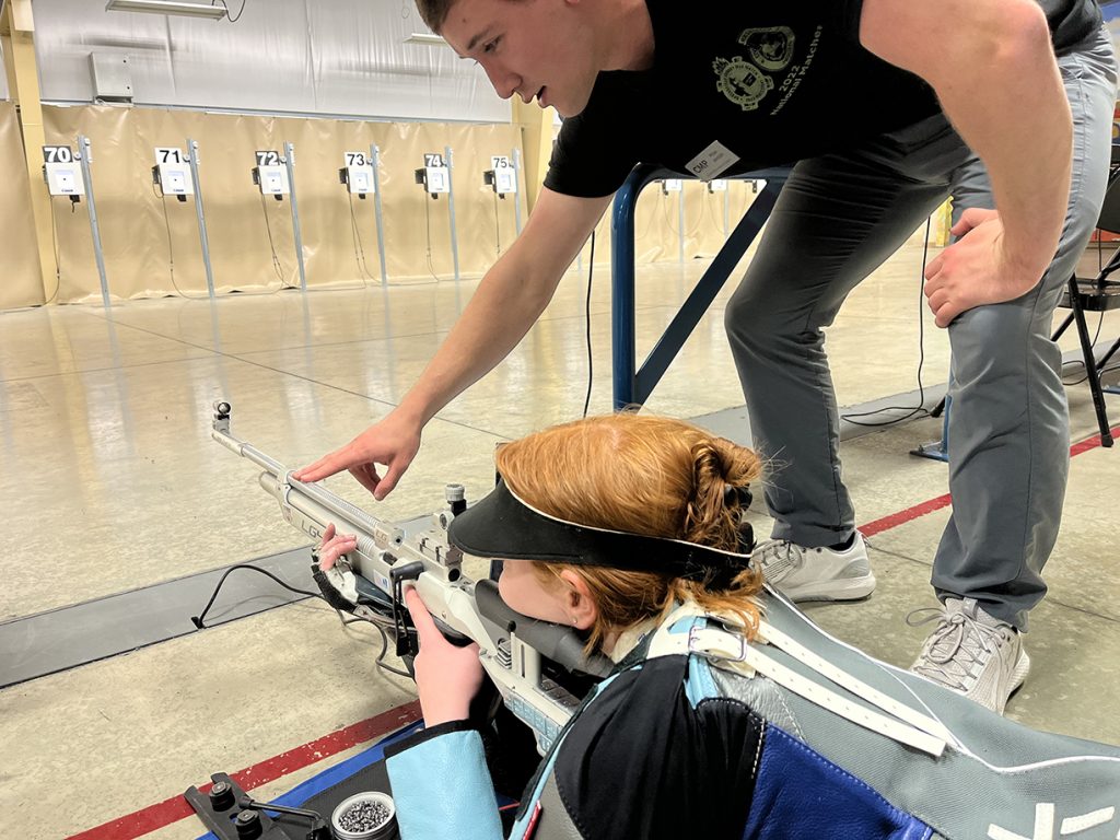 Ryan Hinson coaching a precision shooter in the prone position.