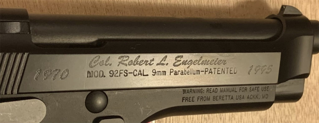 A close-up of the Beretta M-92's engraving of Doc Engelmeier's name.