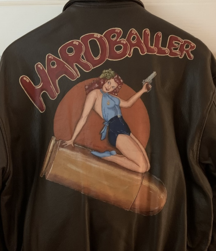 The back of Doc's flight jacket, painted. The word "hardballer" is featured across the top, with the woman riding a .45 caliber bullet in the middle of the back.