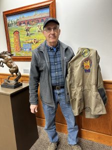 Pat Smith, holding his shooting jacket.