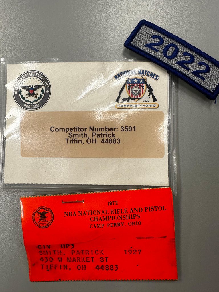 Pat's very first competitor tag, from 1972 (in red) below his most recent tag from 2022.