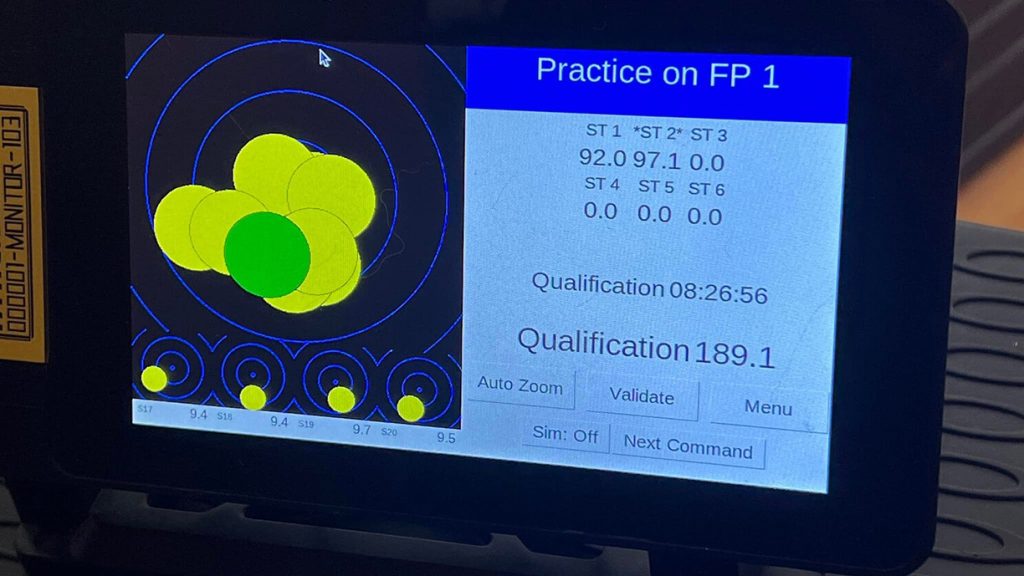 A close up of the Athena electronic target system monitor, displaying shots and scores.