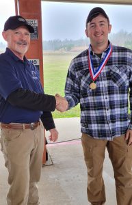 SSG Verne Conant (right) shaking hands with a match official after being awarded a medal.