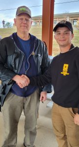 James Diel (left) shaking hands with a member of the U.S. Army Marksmanship Unit.