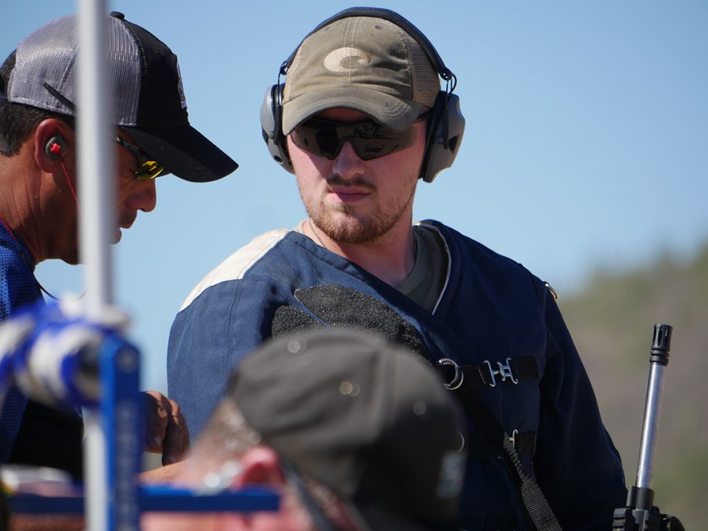 Chris on the firing line with Coach Nick Till.