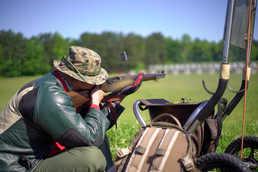Eastern Games competitor firing an M1 Garand with clip ejecting.