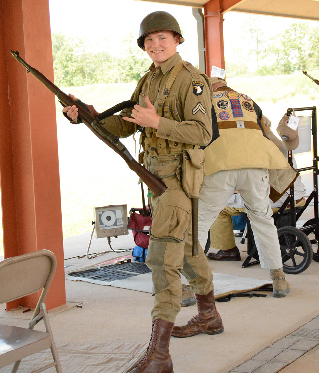 CMP competitor on the firing line dressed up in period uniform with his Garand Rifle.