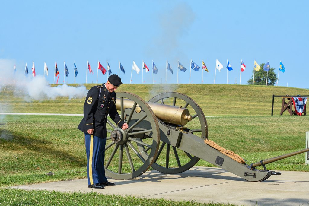 Sgt. 1st Class Brandon Green fires the cannon