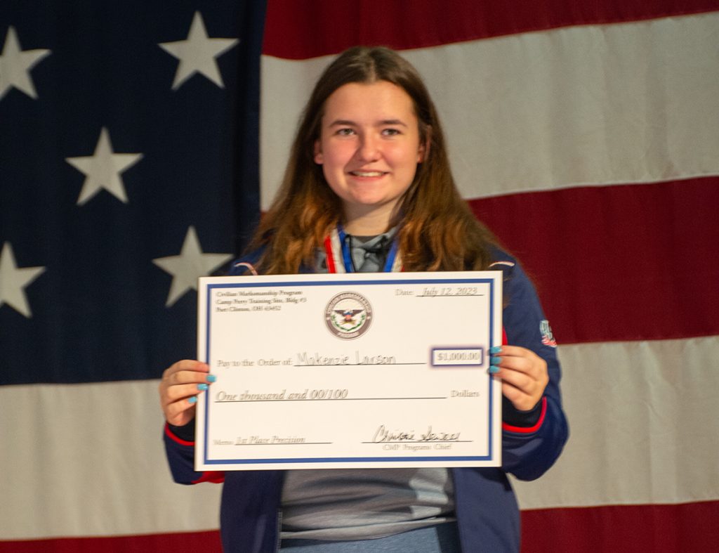 Makenzie holding presentation check for placing first