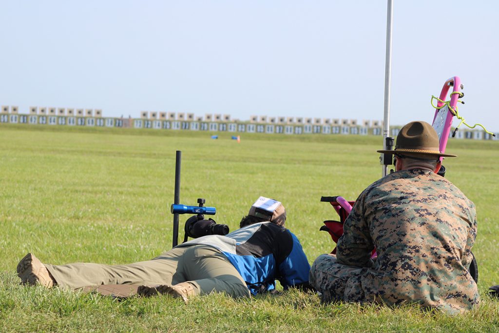 Junior in prone with coach on firing line.