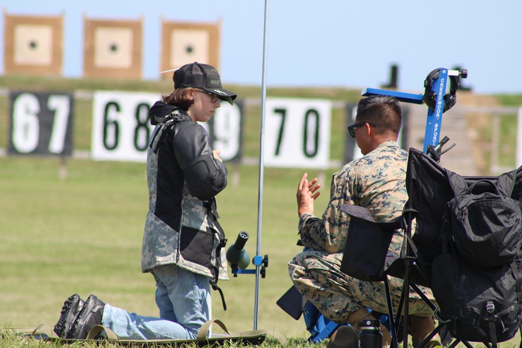 Junior competitor with coach on firing line.