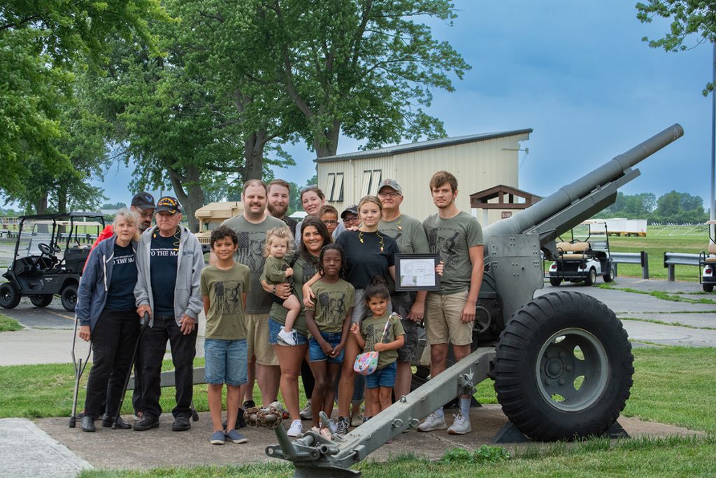 Soviak family poses by cannon.