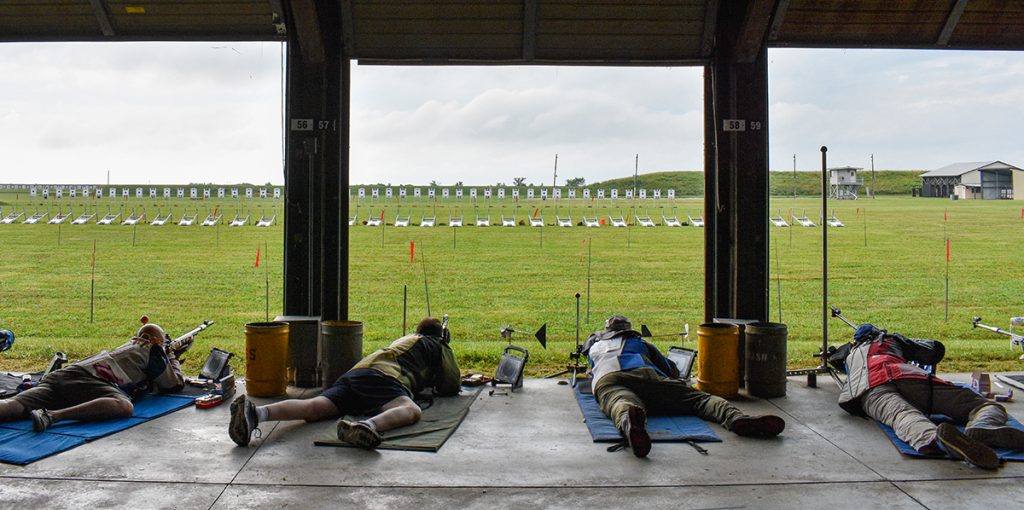 Smallbore prone competitors firing at electronic targets.