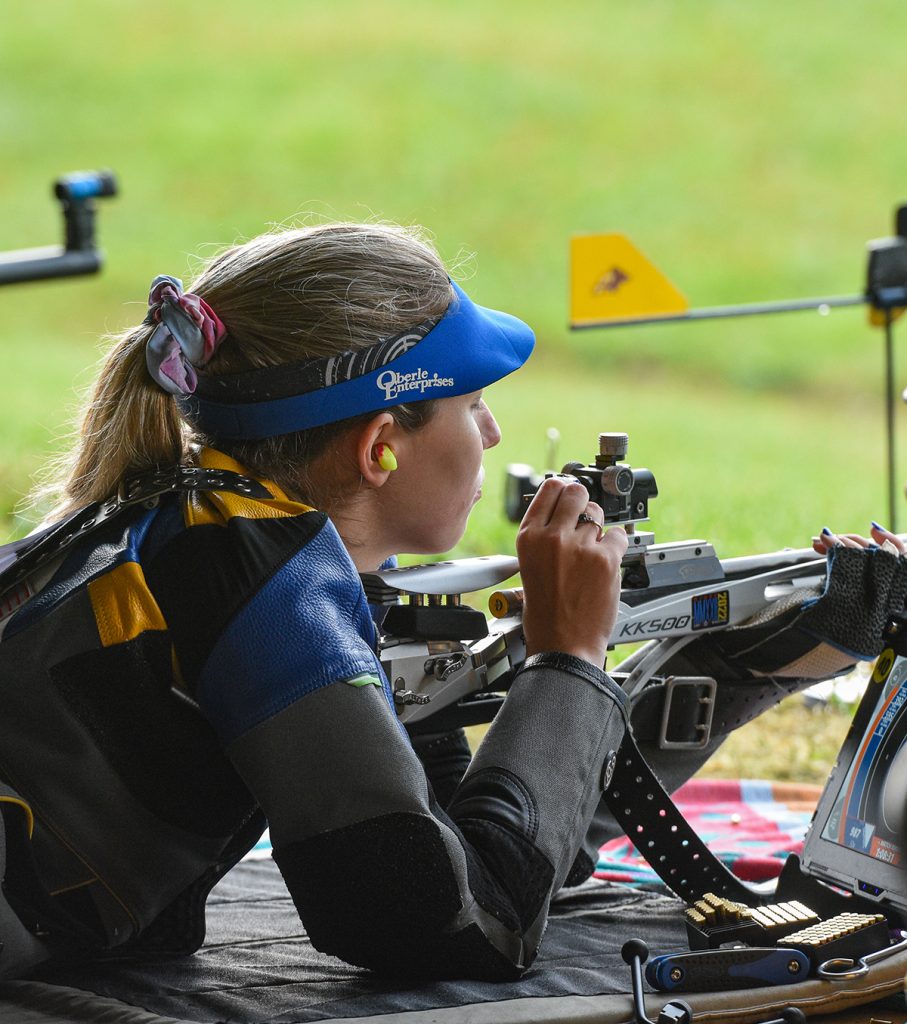 Competitor adjusting sights.