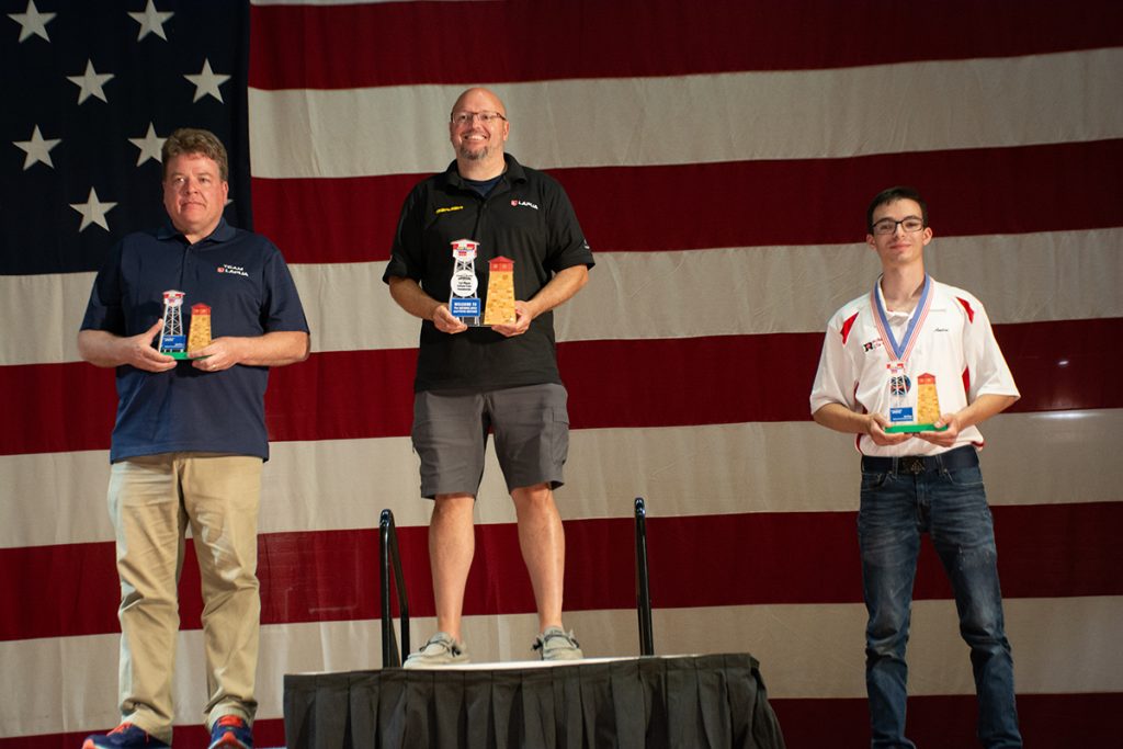 The top three prone competitors on podium.