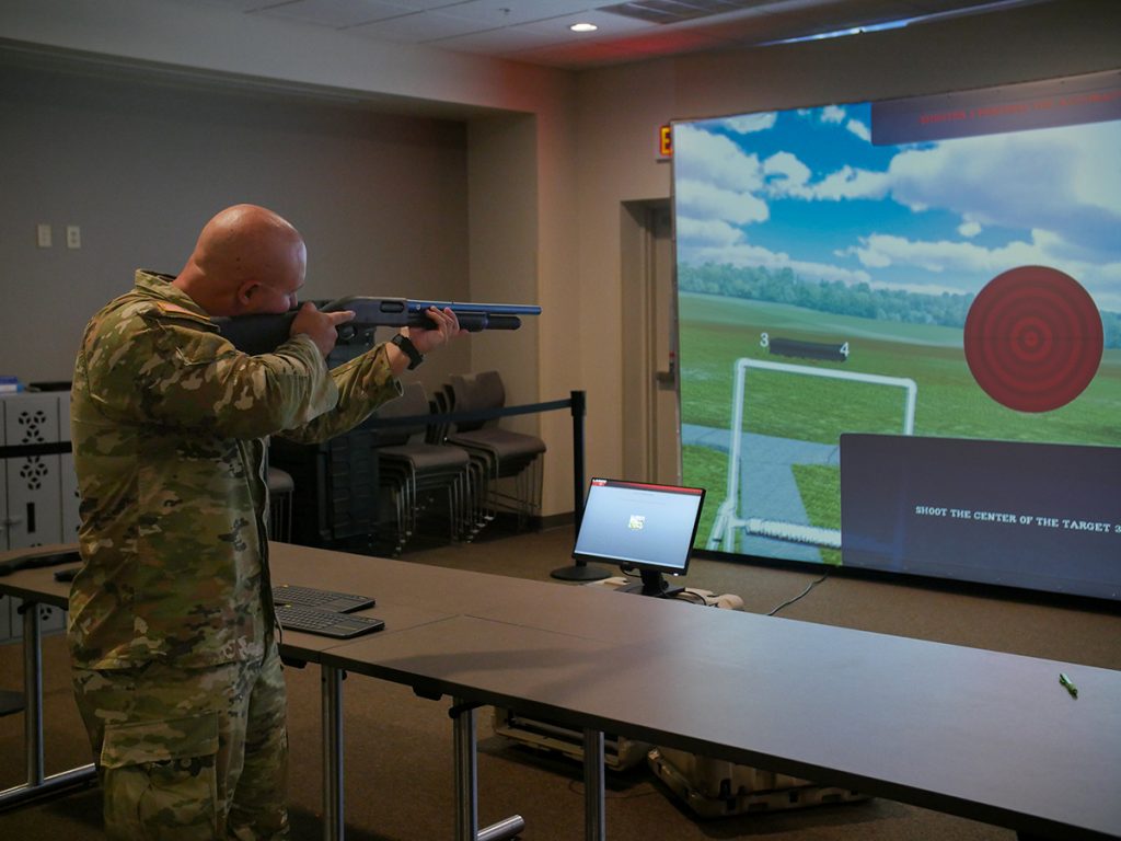 Simulator user aiming at target on screen.