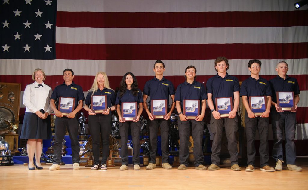 California Grizzlies team with award plaques on stage.