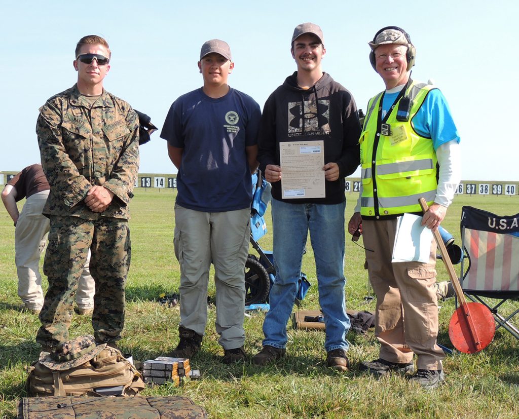 Casey with his coaches from the Small Arms Firing School