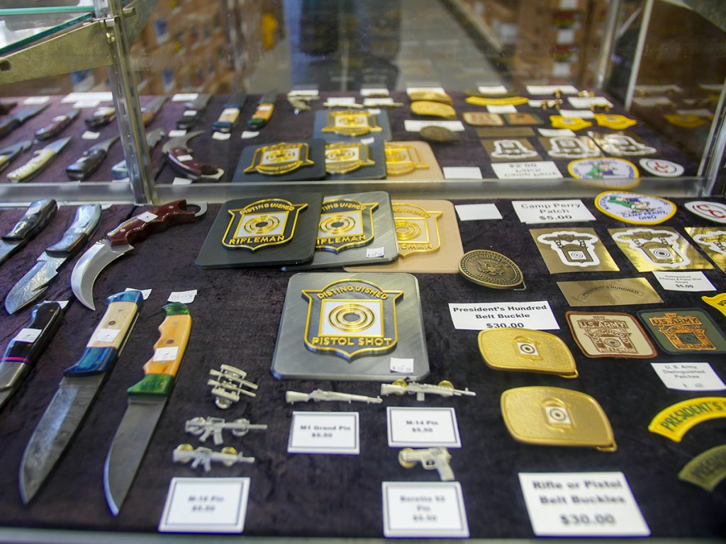 Display of pins, knives and buckles.