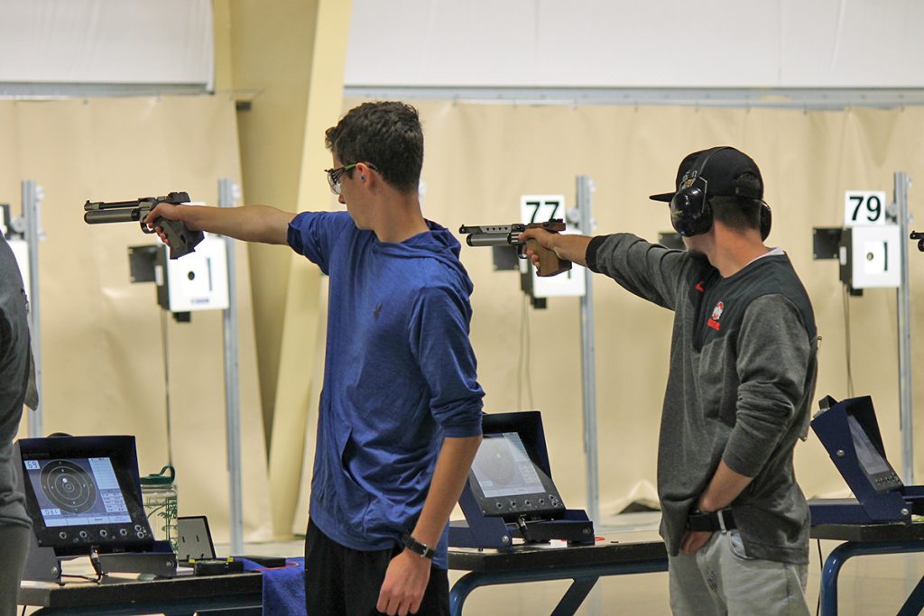 Nick Milev (right) and another competitor aiming air pistol