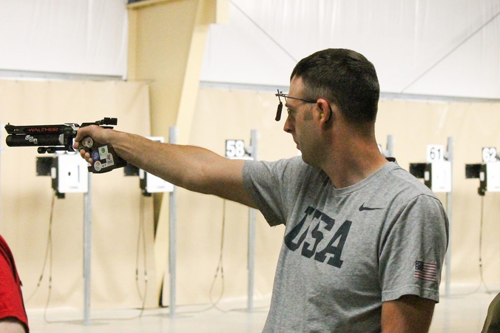 Staff Sgt. Nick Mowrer aiming air pistol
