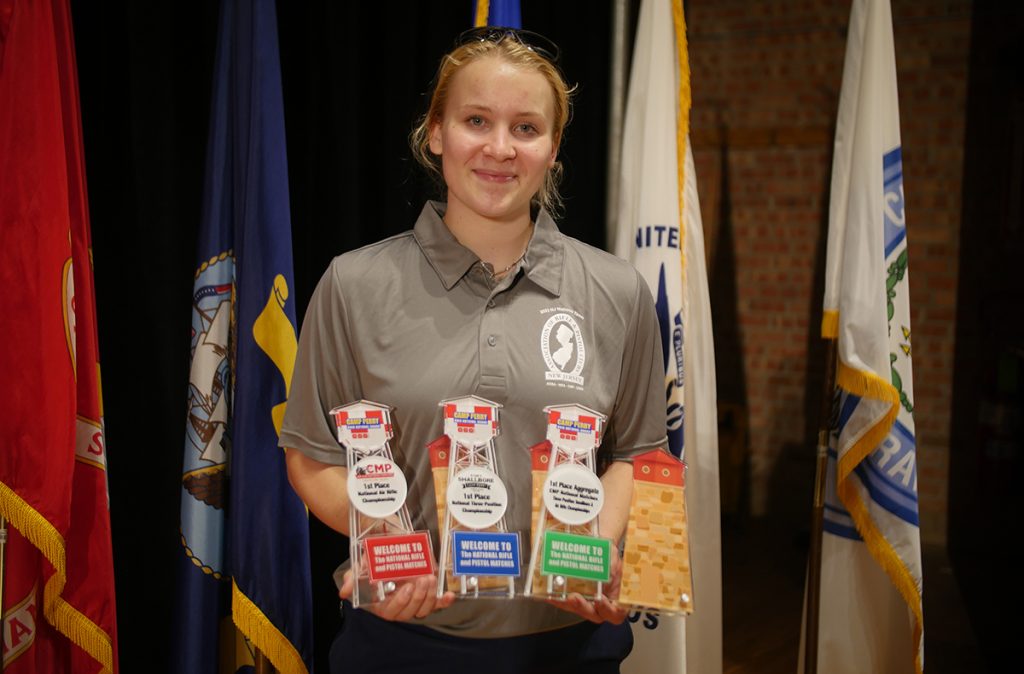 Cecilia Ossi holding the awards she earned during the National Air Gun Championships, including the Air Rifle/Smallbore Aggregate.