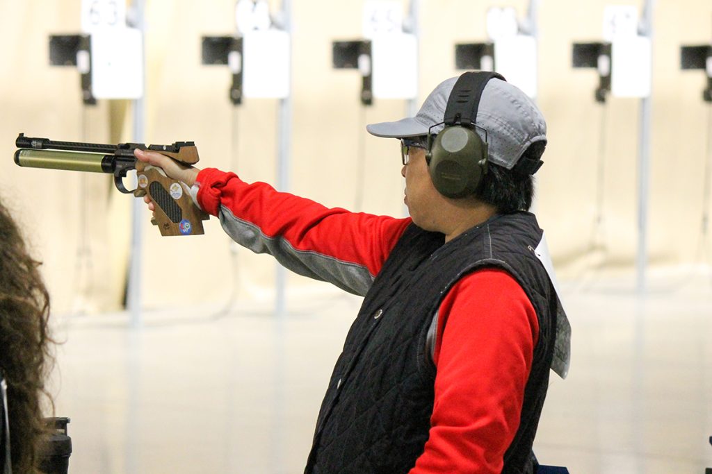 Staff Sgt. Sandra Uptagrafft aiming pistol.