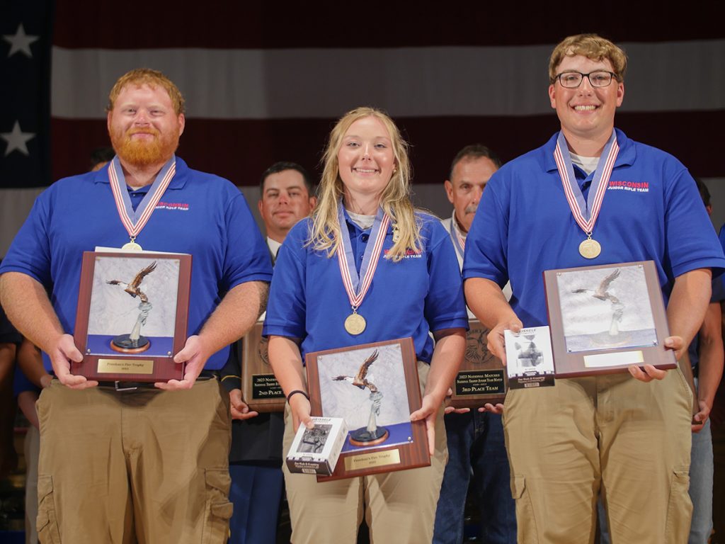 Siblings Thomas and Kacie McGowan, along with Coach Kaleb Hall, received the Freedom's Fire Trophy plaques for placing 1st in the National Trophy Junior Team Match.