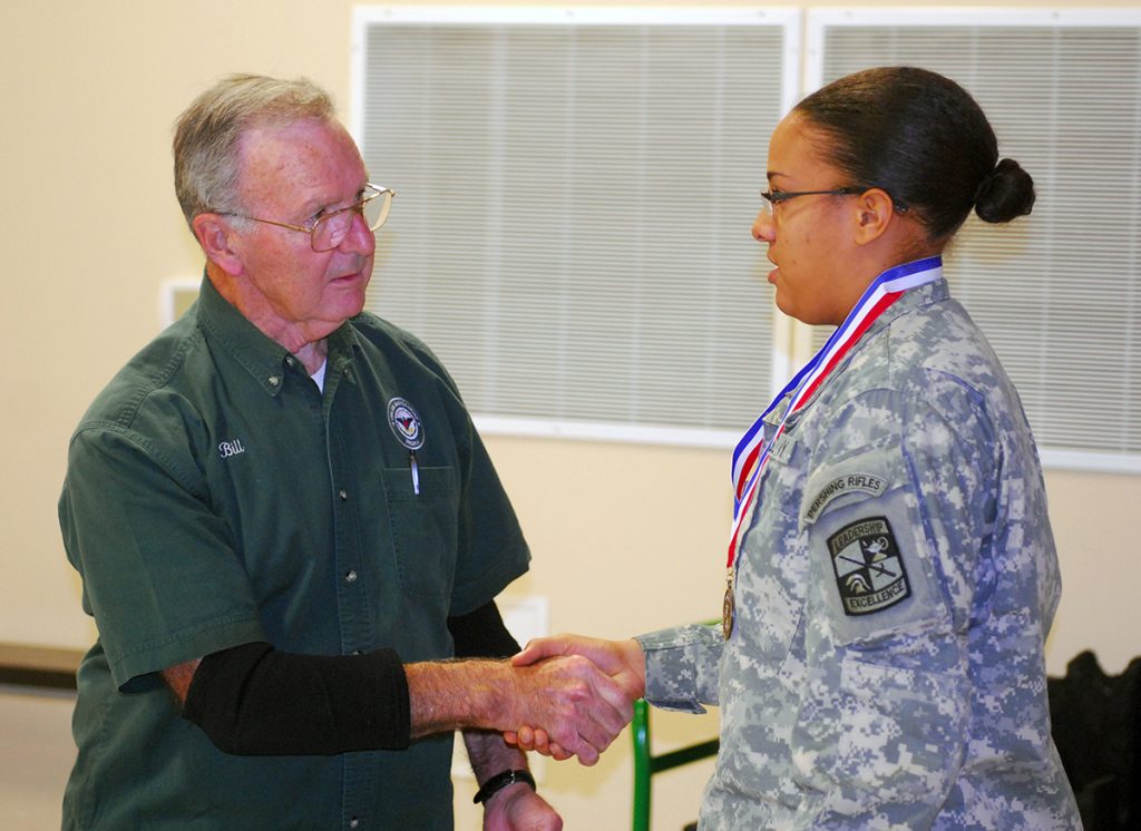 Willoughby awarding medal to JROTC cadet.