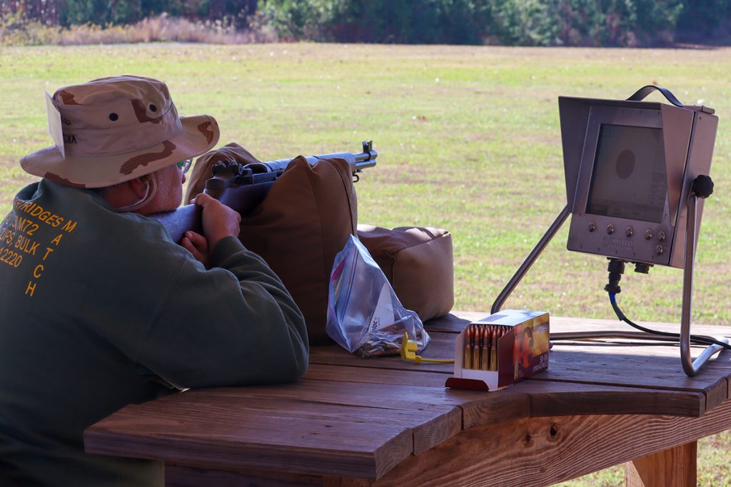 Competitor taking a shot from a bench in a supported position.