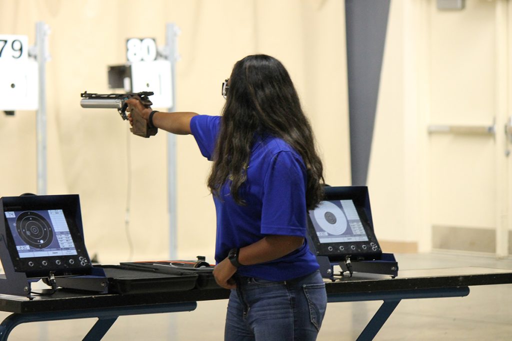 Tanya aiming her air pistol downrange at target.