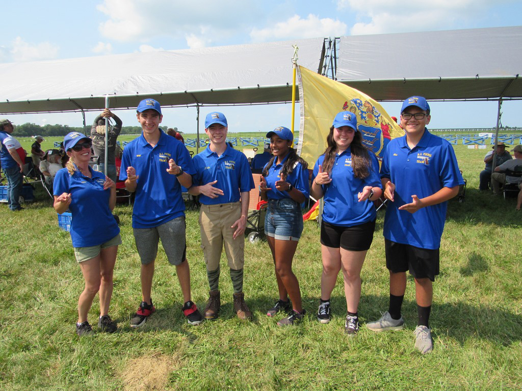 Tanya with teammates posing for a photo on the range.