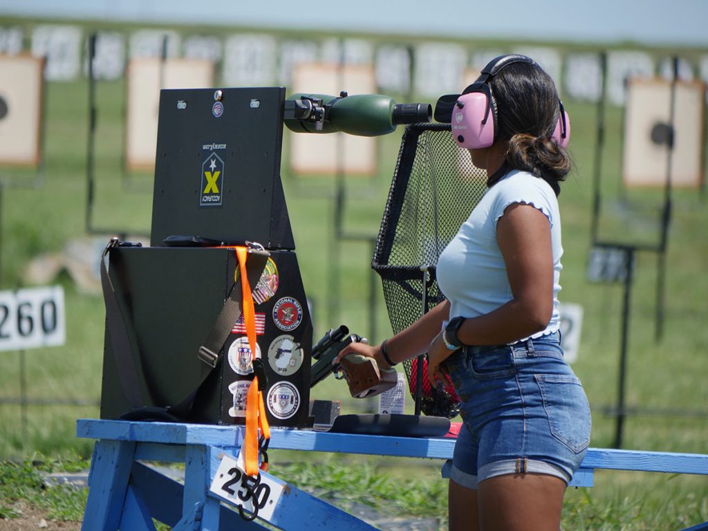 Tanya holding pistol on Camp Perry range.