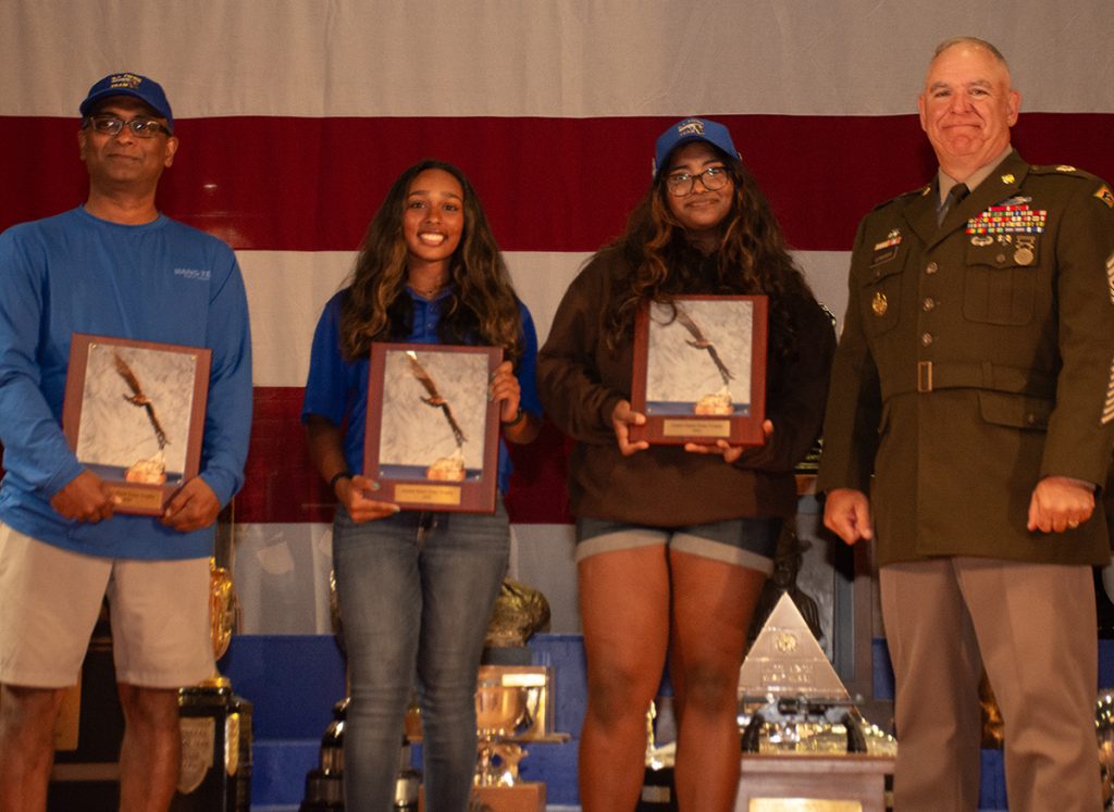 Tanya with her New Jersey teammates receiving an award on stage at Camp Perry.