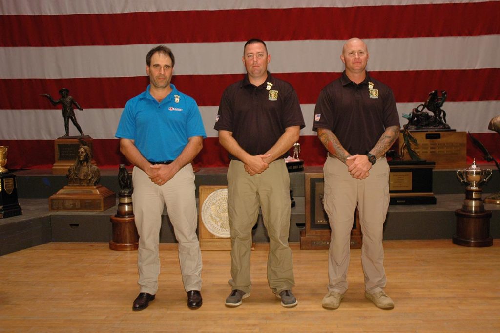 The first three recipients of the .22 Rimfire Pistol Distinguished Badge were all pinned at once during the National Trophy Pistol awards on July 12, 2015.