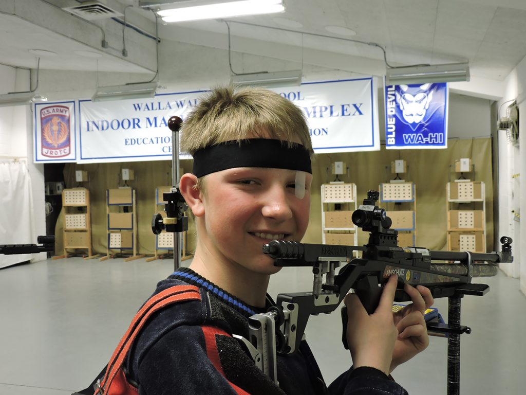 Built for marksmanship, Walla Walla High School has contained a JROTC rifle range since 1906. Today, the range is equipped with electronic targets while also accommodating to paper (shown here by Cadet PFC Brock Betzler) – giving the team ample practice opportunities. 