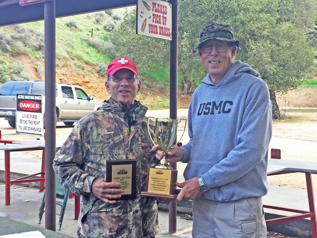 Winner Jim Piini (left) is presented the cup by Carmel Gun Club president, Stephen Hurst (right).
