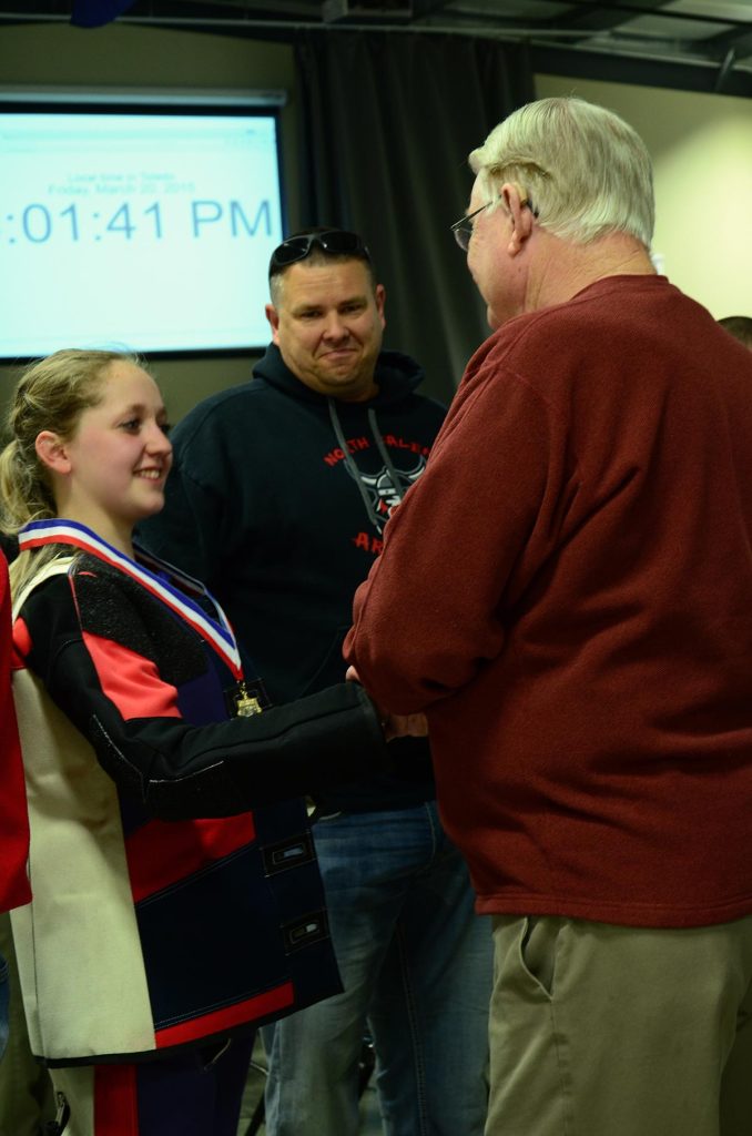 Two-time Olympic Gold Medalist Gary Anderson congratulates Taylor Gibson on her gold medal on Day 1 firing a 690.3. Taylor also set a new Army JROTC national record in kneeling for a score of 200-18X.