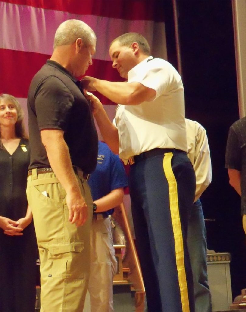 Coach Van Dyke receiving his 2014 Distinguished Rifleman Badge