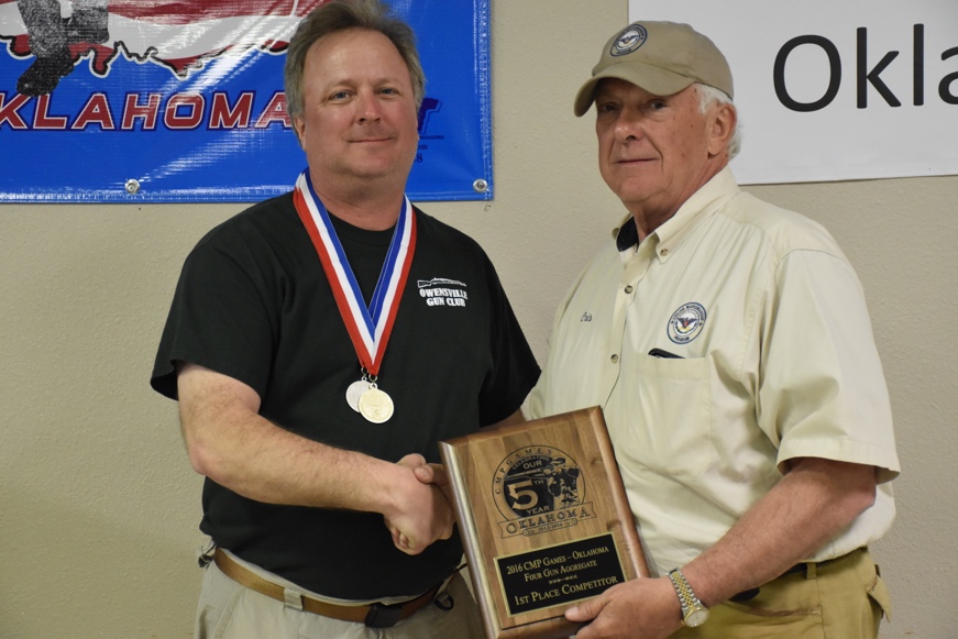 Eric Pauls won the CMP Games - Oklahoma 3-gun and 4-gun vintage military rifle aggregates, the overall CMP Small Arms Firing School M16 EIC Rifle Match and the Vintage Military Rifle Match at Oklahoma City Gun Club. He is congratulated by CMP Vice Chairman Cris Stone.