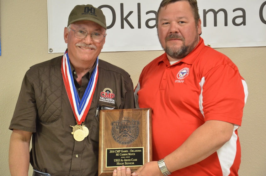 CMP’s Mark Johnson congratulates M1 Carbine high senior James Fletcher, who fired a 360-4x.