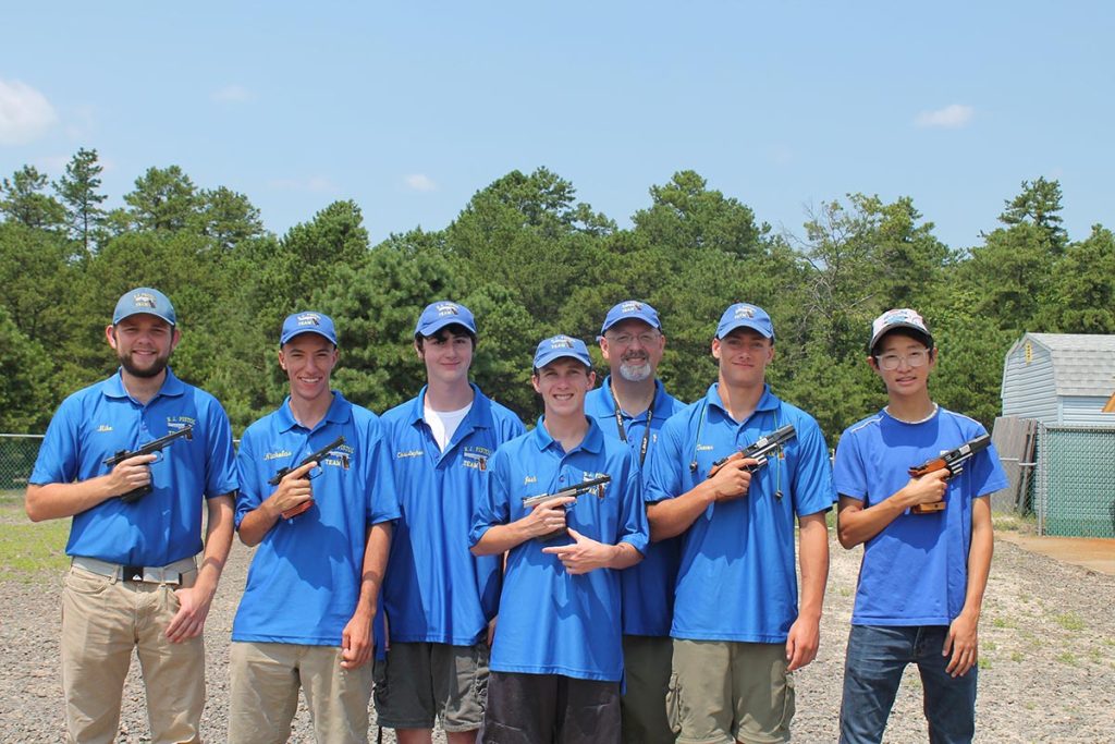 Though he practices with them regularly, Sam (far right) is unable to officially participate at Camp Perry as a member of his New Jersey Pistol Team since he’s not a resident of the state. 