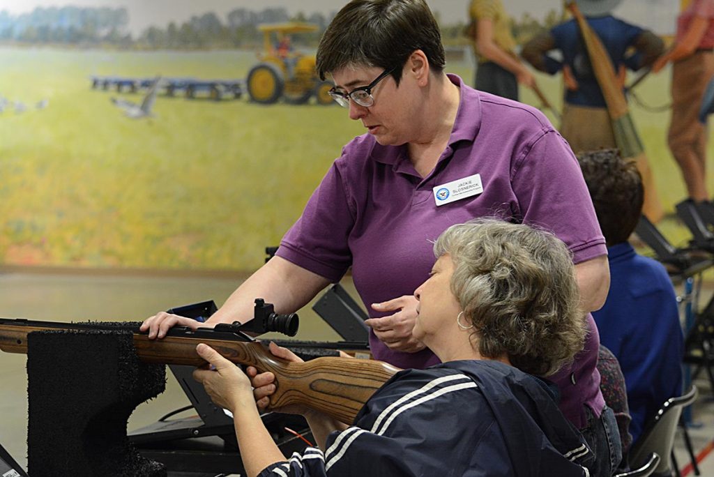 CMP staff member Jackie Slosnerick instructs how to load the air rifle as well as how aim for the perfect shot on the electronic targets downrange. Many staff members were on hand to offer help to those who may have been new to the air range.