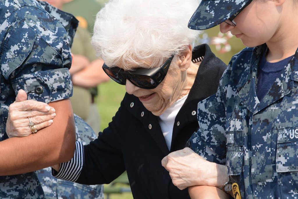 At 91-years-old, Minnie was still strong enough to walk herself (with just a little help) to deliver the colors. The crowd cheered and clapped for the true American hero before them.