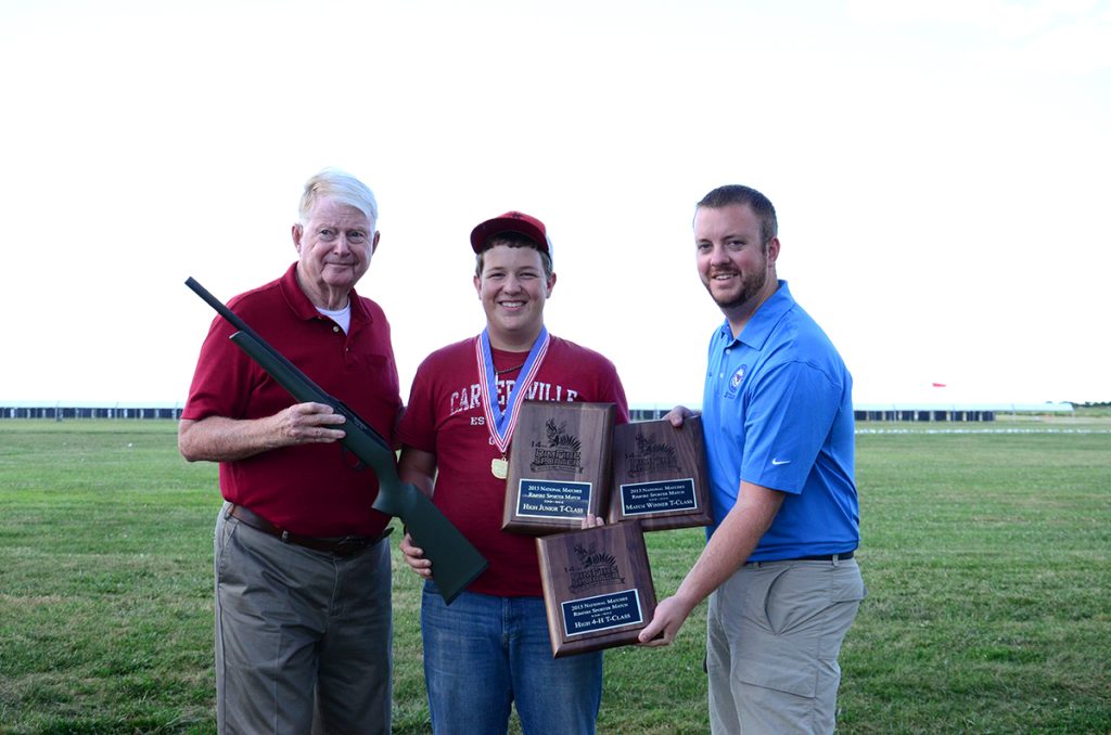 Samuel Payne of Kingston, GA, was the match winner of the T-Class with an exceptional score of 599-46x. He was also the high junior, the high 4-H junior and set a new National Record. Payne was awarded his plaques by DCM Emeritus Gary Anderson (left), as well as CMP staff member Brad Donoho (right), who called the Rimfire Sporter Match. 