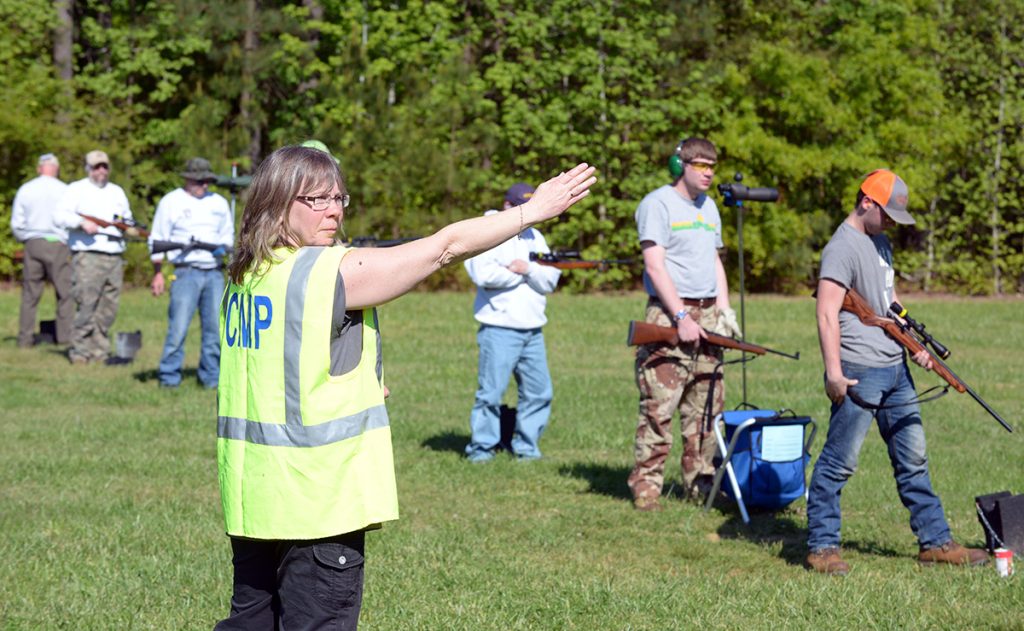 A CMP Range Officer is signaling to the CRO that “the line is ready” in a CMP Rimfire Sporter Match.  A new CMP Range Officer Training Course will soon be available to train volunteer Range Officers to serve in competitions the CMP governs and sanctions.