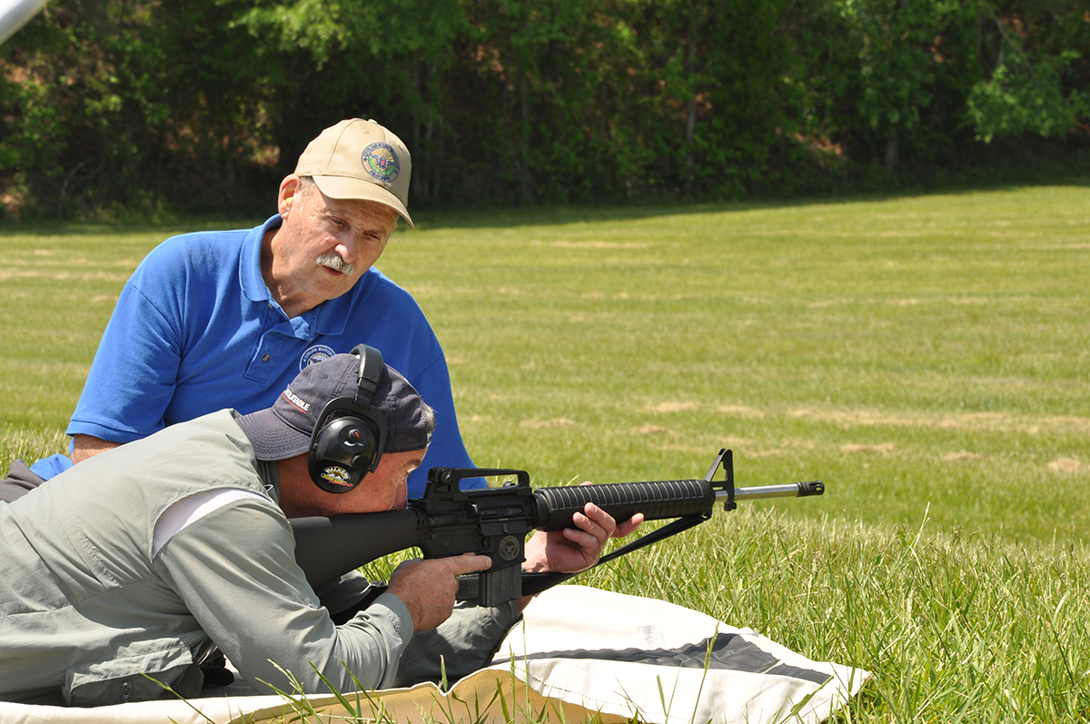 A CMP Master Instructor helps a student during the CMP Travel Games Small Arms Firing School