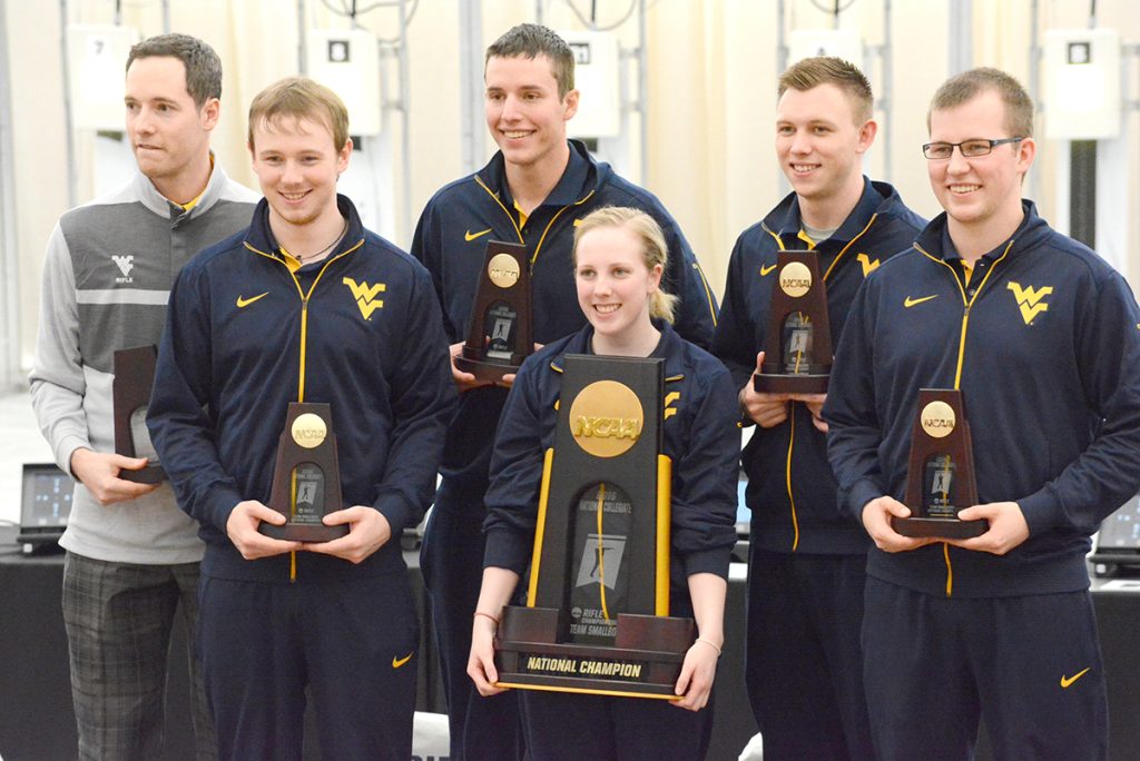 With her outstanding performance at NCAA Nationals, Ginny Thrasher helped her team receive its fourth consecutive National Title – led by coach and Olympian Jon Hammond (left). 