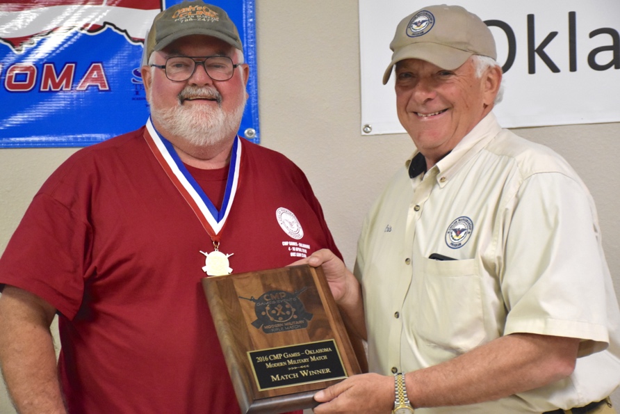 CMP Vice Chairman Cris Stone presents William Fairless the award for high Springfield Rifle match winner and high senior, scoring an aggregate of 279-7x. Fairless was also high senior and winner of the Modern Military Rifle match with a score of 289-7x.